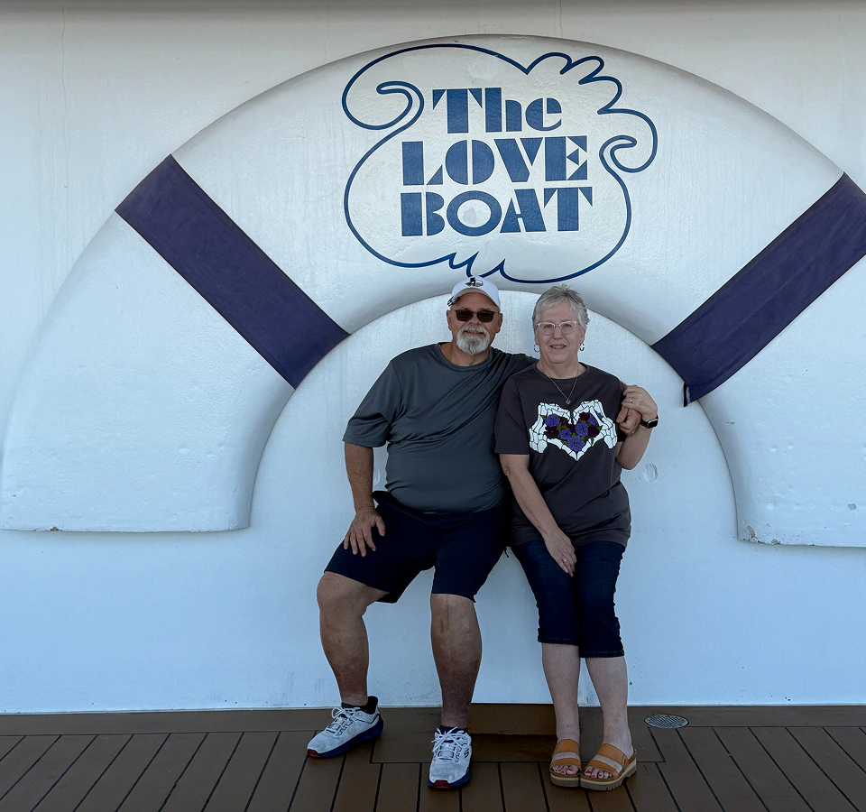 Margie and her husband enjoying a cruise