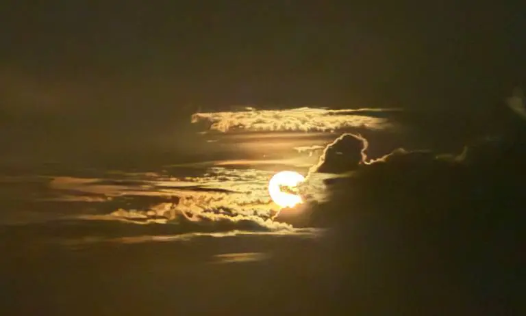 The sun glowing through golden clouds