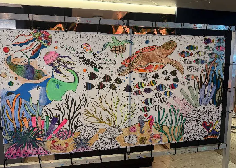 A colorful mural of turtles, fish, and coral